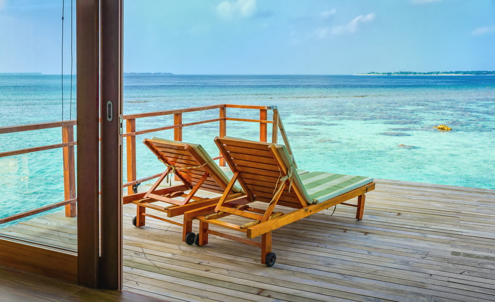 Loungers on the deck on an overwater bungalow
